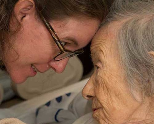 a Hospice nurse and patient share an intimate moment