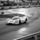 Porsche racing car on wet pavement